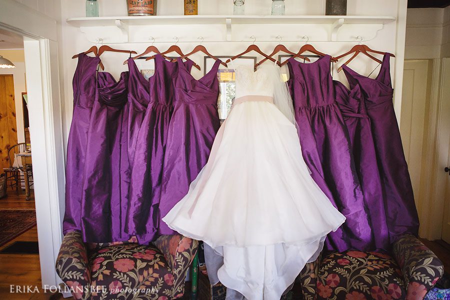 wedding gown and bridesmaids dresses hanging up