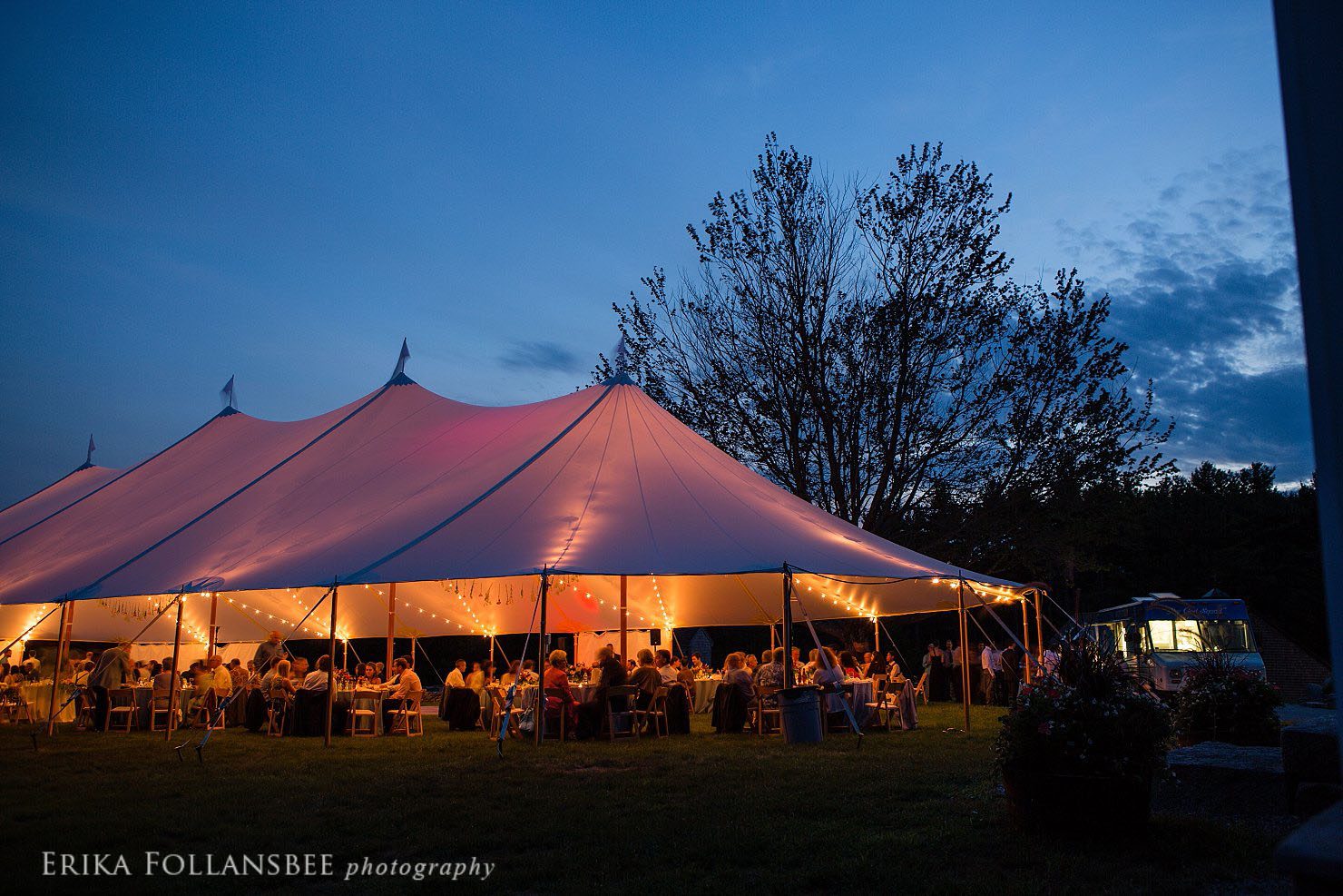 The sailcloth tent glows festively against the evening sky