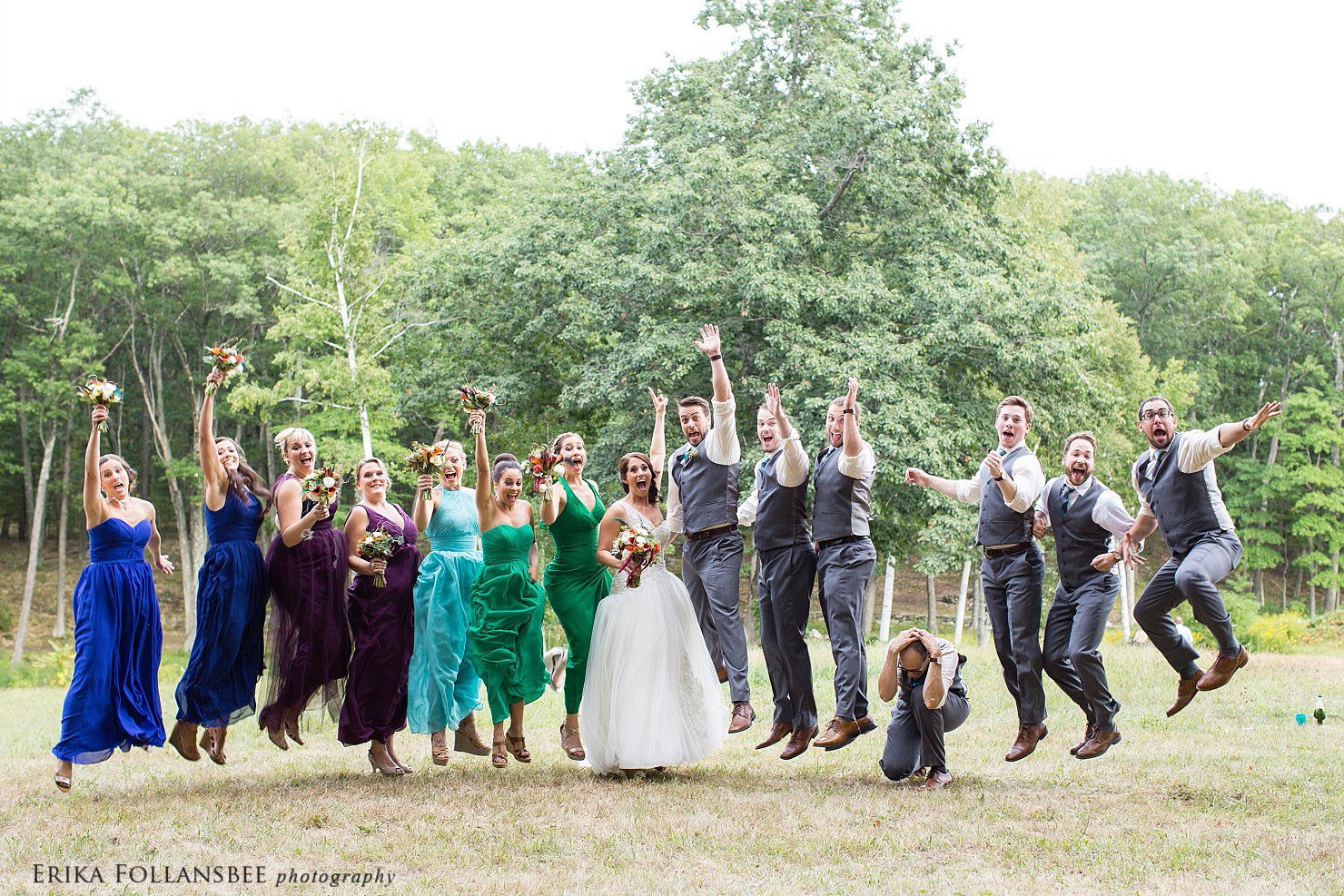 bridal party jumping into the air