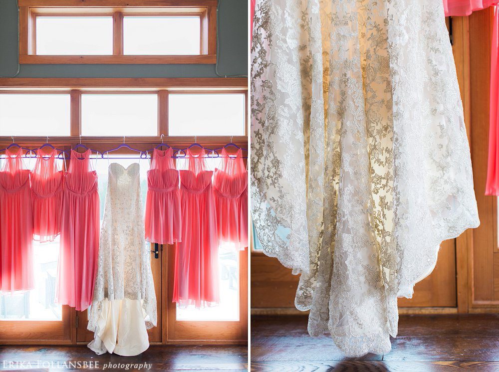 Wedding dress and bridesmaids dresses hanging in a windo