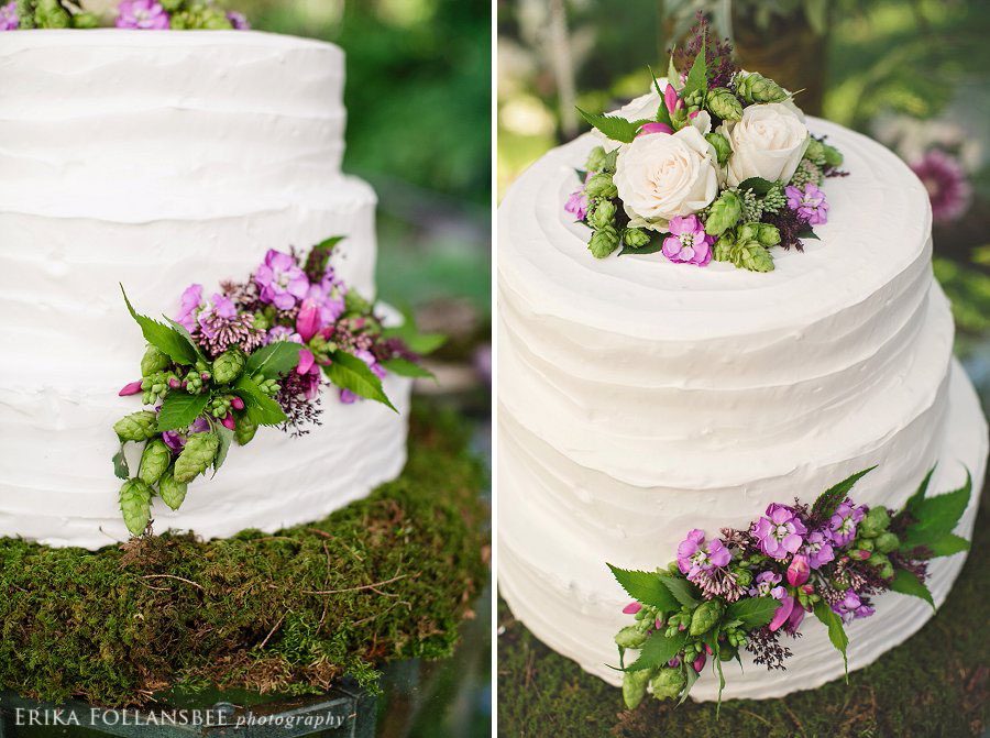 rough frosted white cake with white roses and green hops