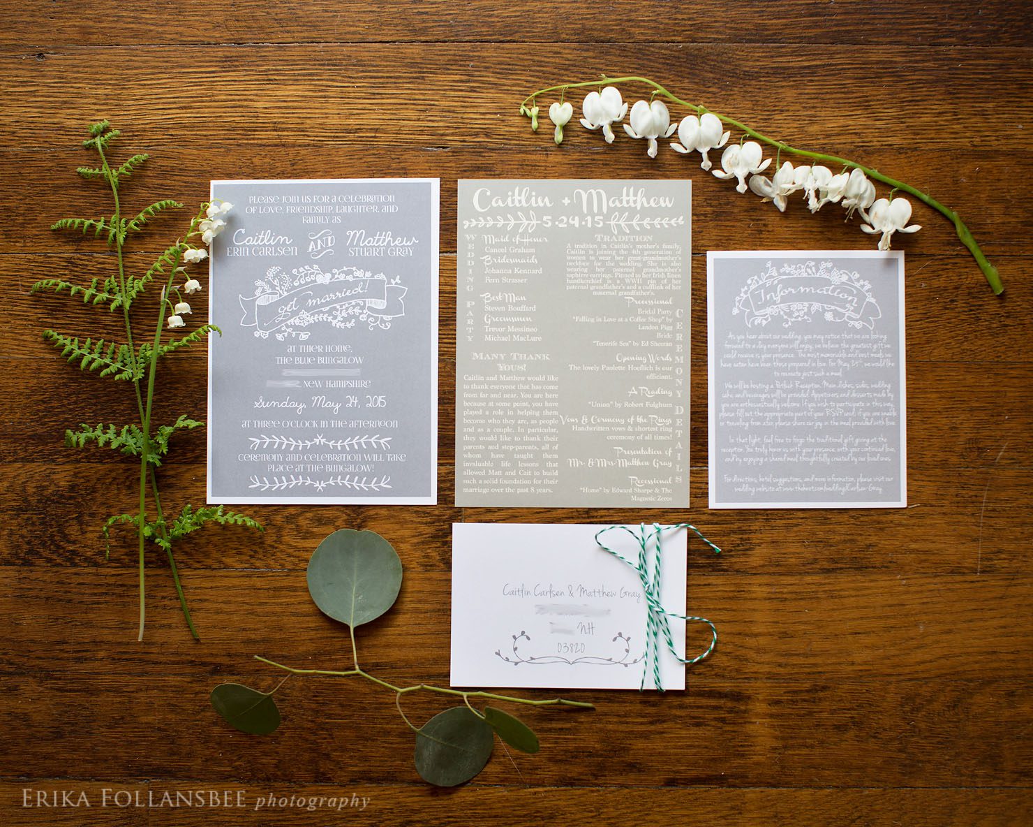 gray invitation suite with wood background